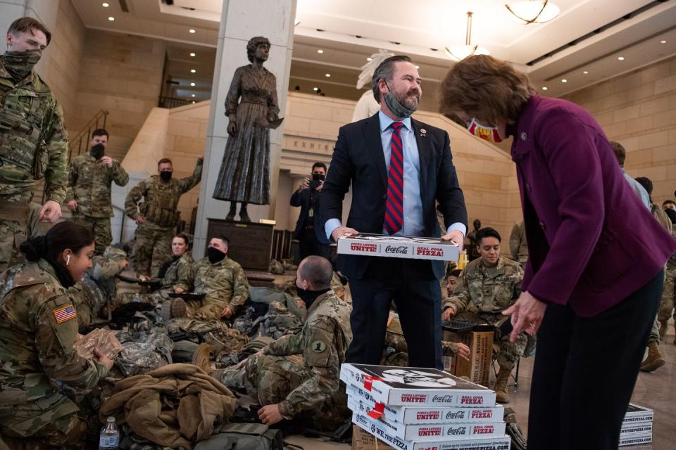 <p>Reps. Michael Waltz, R-Fla., and Vicky Hartzler, R-Mo., deliver pizza to members of the Delaware National Guard in the Capitol Visitor Center in Washington, DC, January 13, 2021.</p>