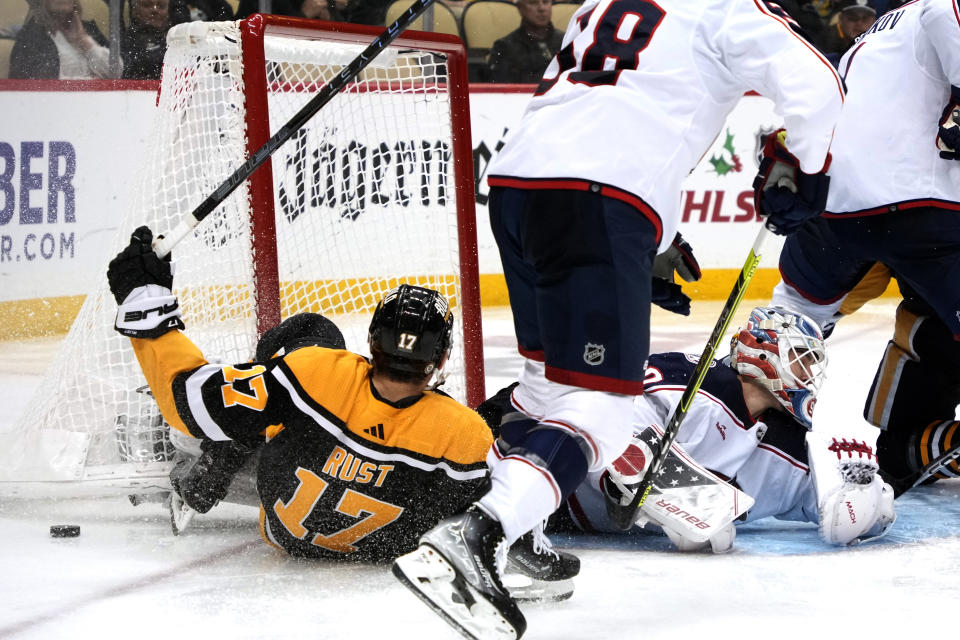 Pittsburgh Penguins' Bryan Rust (17) gets a shot past Columbus Blue Jackets goaltender Elvis Merzlikins for a goal during the second period of an NHL hockey game in Pittsburgh, Tuesday, Dec. 6, 2022. (AP Photo/Gene J. Puskar)