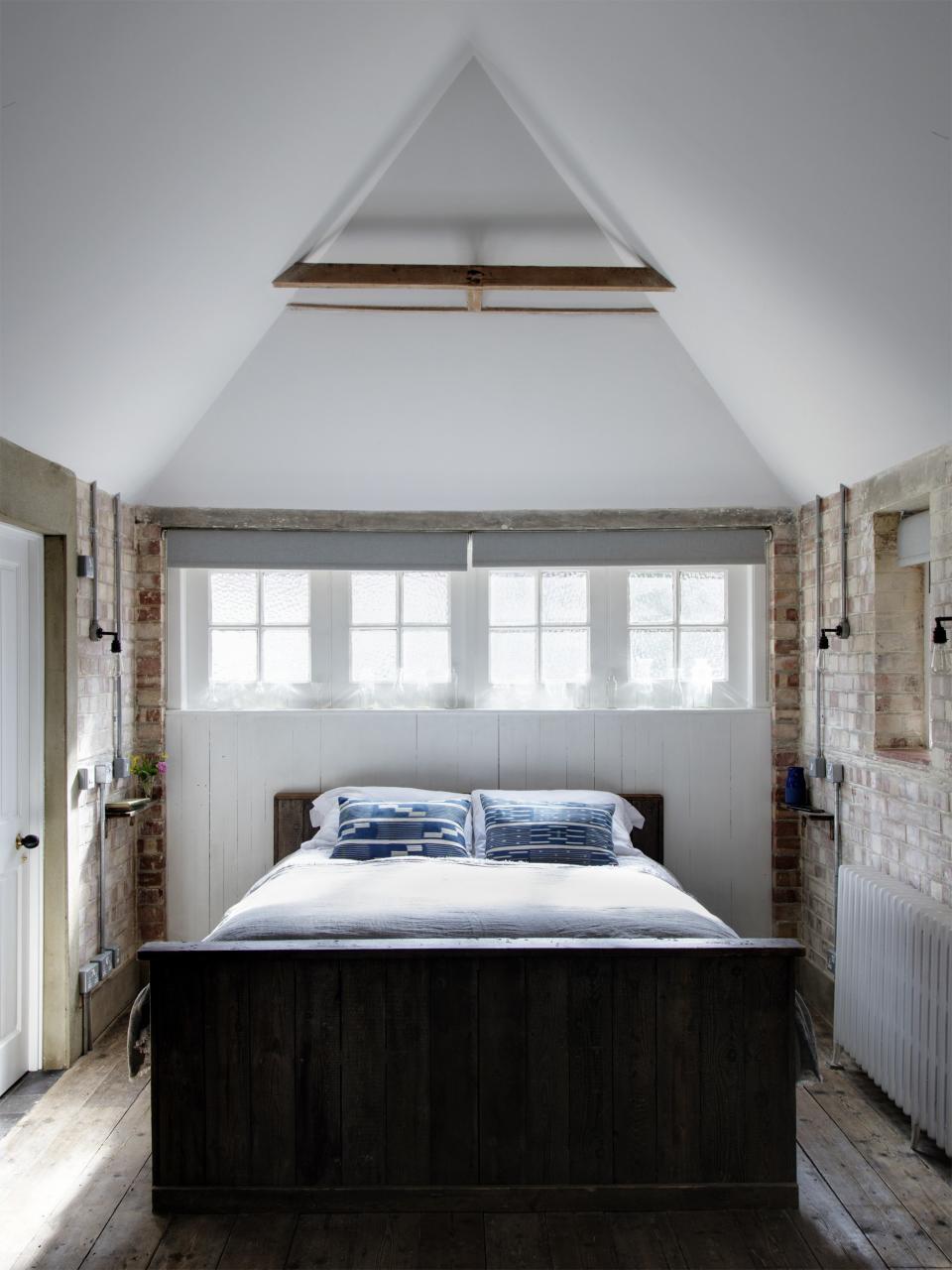 Just wide enough to fit a bed, the former garage looks like an A-frame cabin in the woods from the inside. An added skylight drops a beam of sunlight right on the duvet.
