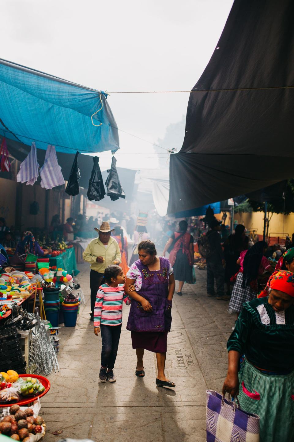 Visitors to the Sunday market in Tlacolula stroll through the corridor of vendors that sell produce, textiles, ceramics, wood carvings, clothing, electronics, and any other items one might need.