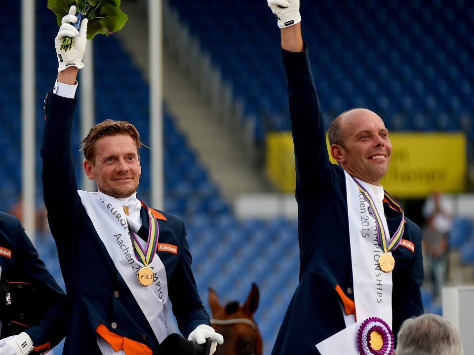 The Dutch equestrian team standing on a podium with medals