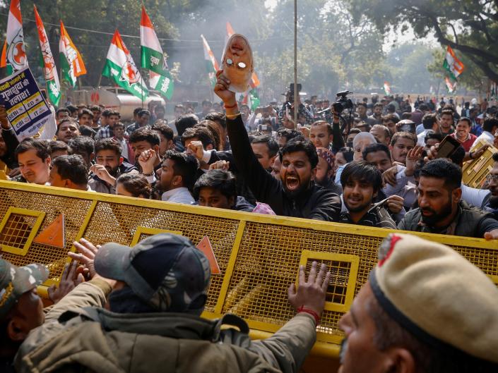 Activists of the youth wing of India's main opposition Congress party try to break a police barricade during a protest against what they say are investments by Life Insurance Corporation (LIC) and State Bank of India (SBI) in Adani Group, in New Delhi, India, February 6, 2023.