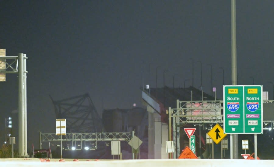 Parts of the Francis Scott Key Bridge remain after a container ship collided with a support Tuesday, March 26, 2024, in Baltimore. The major bridge in Baltimore snapped and collapsed after a container ship rammed into it early Tuesday, and several vehicles fell into the river below. Rescuers were searching for multiple people in the water. (AP Photo/Steve Ruark)