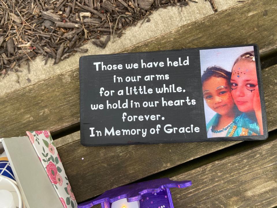 A photo of Grace Ross, 6, was one of the items placed on a park bench at a Memorial Park vigil held in honor of the girl who was killed in March 2021.