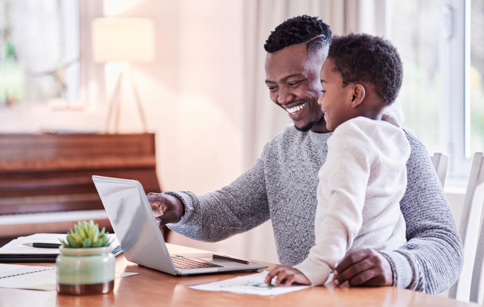 Father and son using laptop