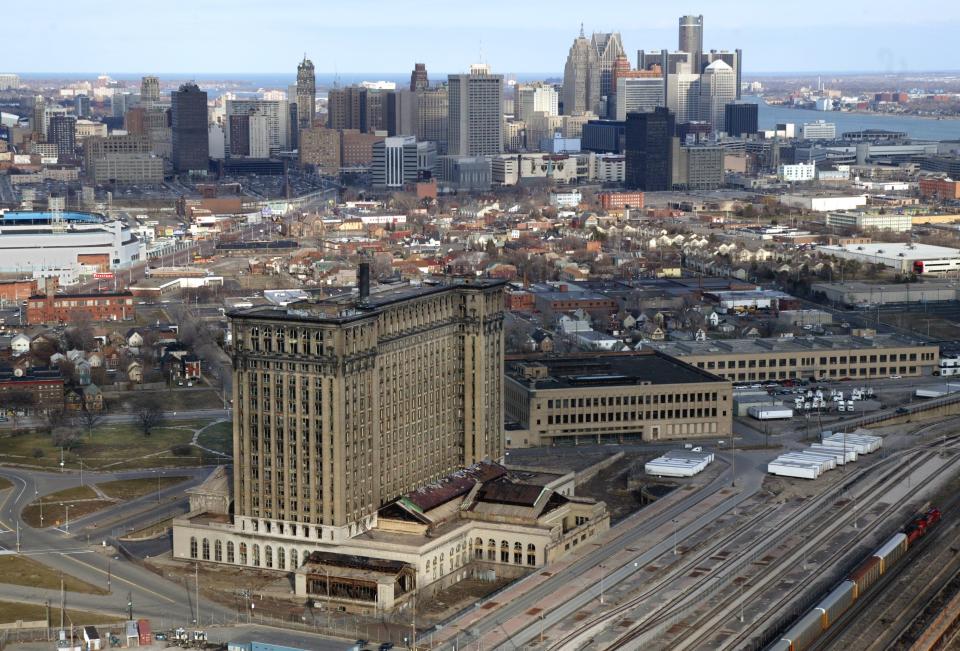 The massive abandoned and vacant Michigan Central Railroad depot rises in front of the skyline of downtown Detroit on Monday, March 15, 2004.