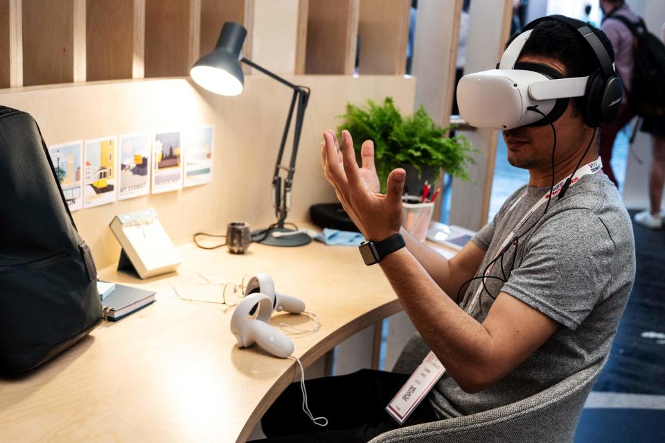 An attendee tries out a Meta virtual reality headset during the Vivatech technology startups and innovation fair in Paris on May 15, 2022. (Photo by BERTRAND GUAY / AFP) (Photo by BERTRAND GUAY/AFP via Getty Images)