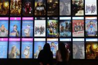 People look at the movies screen board at Mall of the Emirates during the reopening of malls, following the outbreak of the coronavirus disease (COVID-19), in Dubai