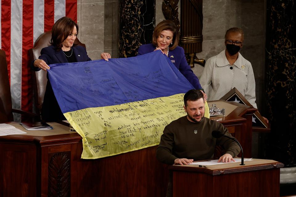 Nancy Pelosi and vice president Kamala Harris hold a Ukrainian flag signed by members of its military, given to them by Volodymyr Zelensky (Chip Somodevilla/Getty Images)