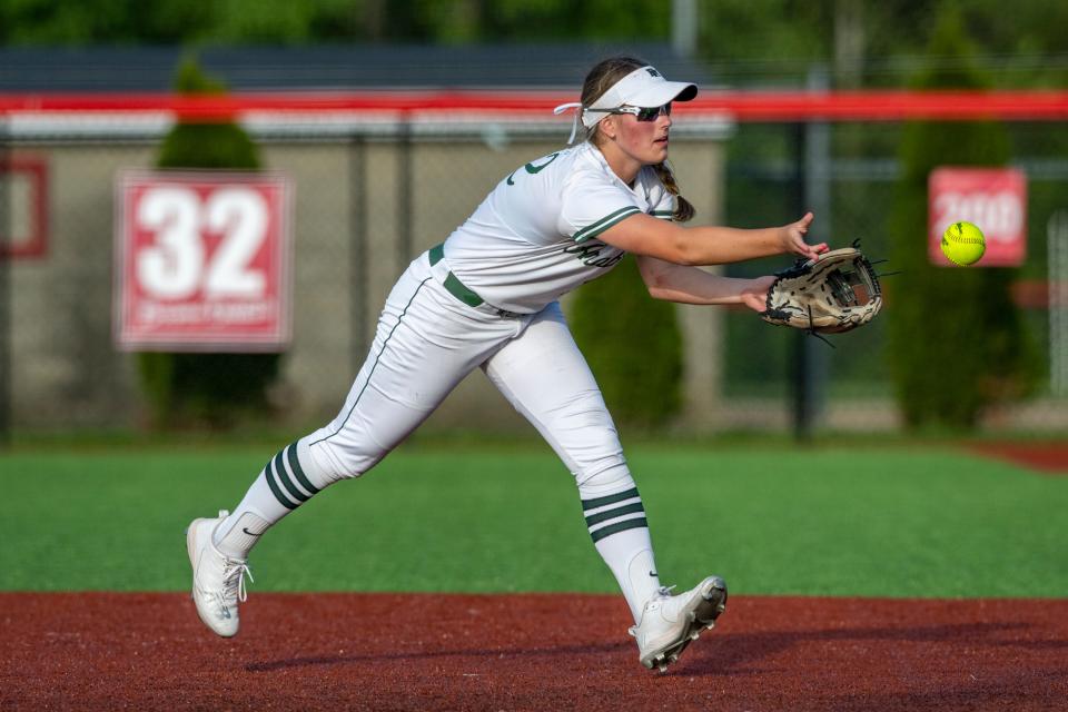 Pendleton Heights High School junior Alana Smith (12) shuffles a pass to first base for an out during a IHSAA Class 4A Softball Sectional Championship game against New Palestine High School, Thursday, May 25, 2023, at New Palestine High School.