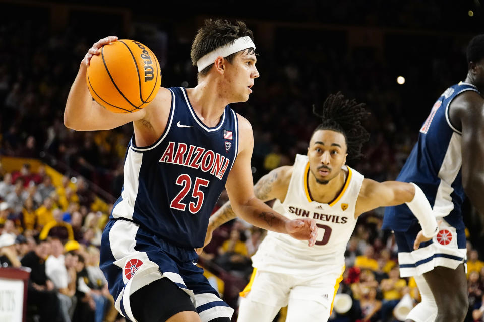 Arizona's Kerr Kriisa (25) drives past Arizona State's Frankie Collins (10) during the second half of an NCAA college basketball game, Saturday, Dec. 31, 2022, in Tempe, Ariz. (AP Photo/Darryl Webb)