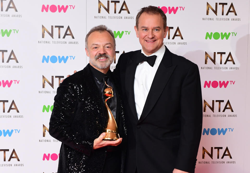 Hugh Bonneville with Graham Norton in the press room who received the Special Recognition Award at the National Television Awards 2017, held at The O2 Arena, London. PRESS ASSOCIATION Photo. Picture date: 25th January, 2017. See PA Story SHOWBIZ NTAs. Photo credit should read: Ian West/PA Wire (Photo by Ian West/PA Images via Getty Images)