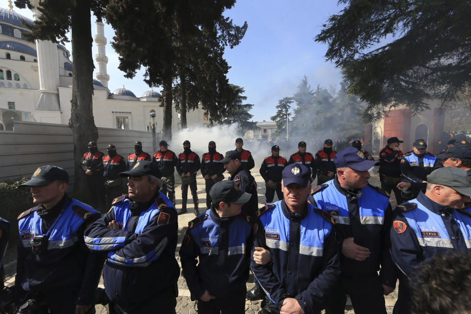 Police officers stand guard during an anti-government rally in Tirana, Albania, Thursday, March 21, 2019. Thousand opposition protesters have gathered in front of Albania's parliament building calling for the government's resignation and an early election. Rally is part of the center-right Democratic Party-led opposition's protests over the last month accusing the leftist Socialist Party government of Prime Minister Edi Rama of being corrupt and linked to organized crime. (AP Photo/ Hektor Pustina)