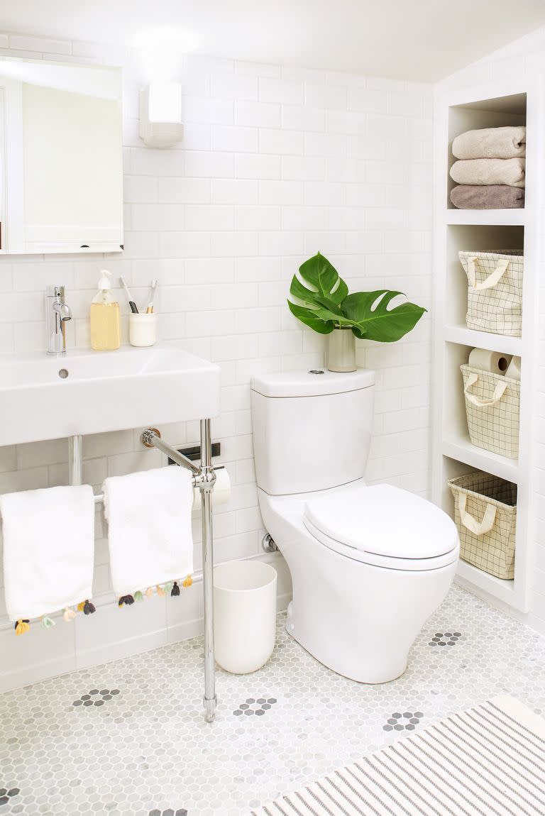 bathroom storage ideas, white bathroom with open built in shelves and baskets inside