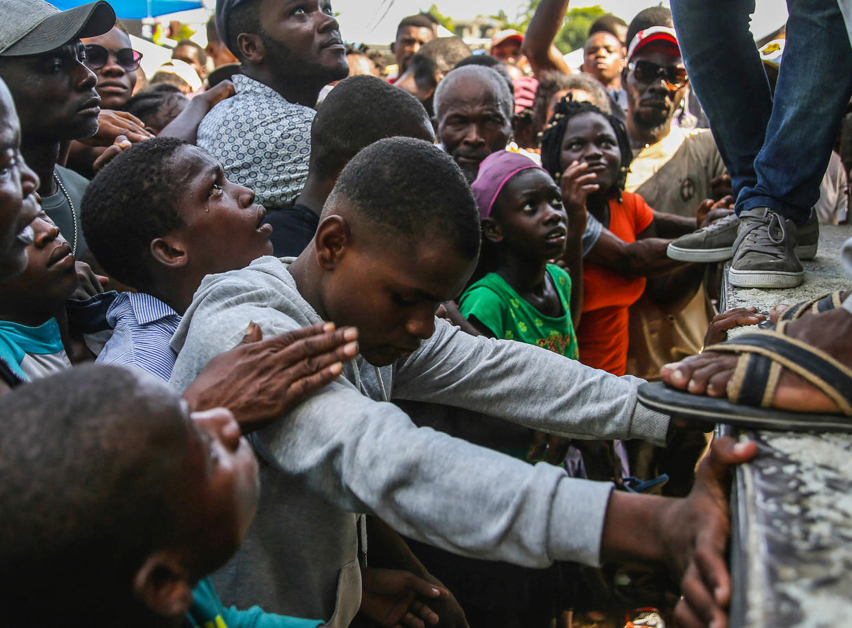 Residents wait for food distribution two days after a 7.2-magnitude earthquake hit, in Les Cayes, Haiti, Aug. 16, 2021.