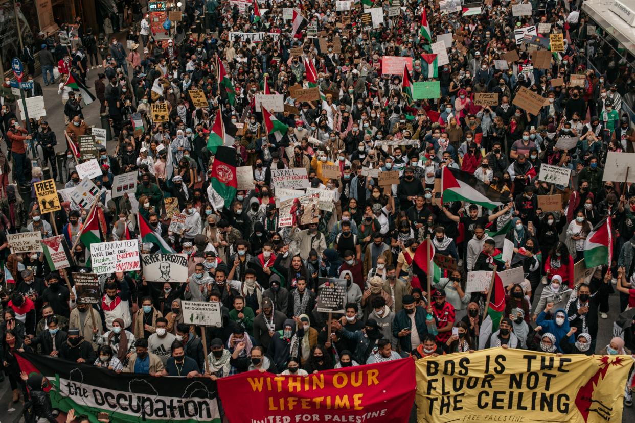 Protesters demanding an end to Israeli aggression against Palestine march in the street in Midtown Manhattan on May 11, 2021, in New York City. Recent violence between the Israeli military and Palestinians in Jerusalem has left dozens dead as activists around the world denounce attacks on the city's Al-Aqsa Mosque.