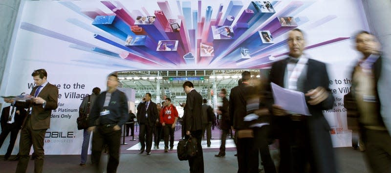 Visitors walk through the Mobile World Congress in Barcelona