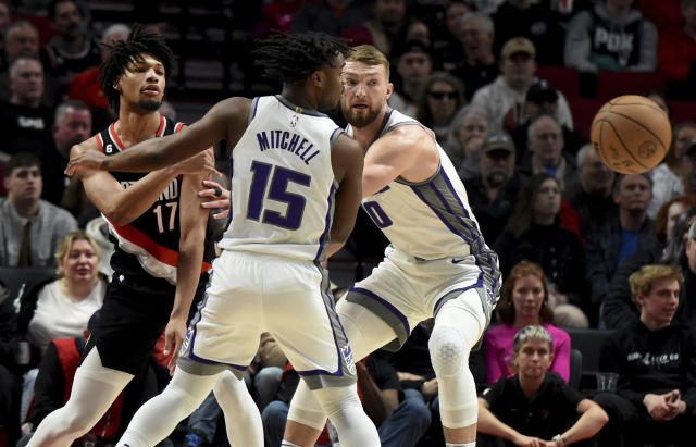 Portland Trail Blazers guard Shaedon Sharpe, left, passes the ball around Sacramento Kings guard Davion Mitchell, center, and forward Domantas Sabonis, right, during the first half of an NBA basketball game in Portland, Ore., Friday, March 31, 2023. (AP Photo/Steve Dykes)