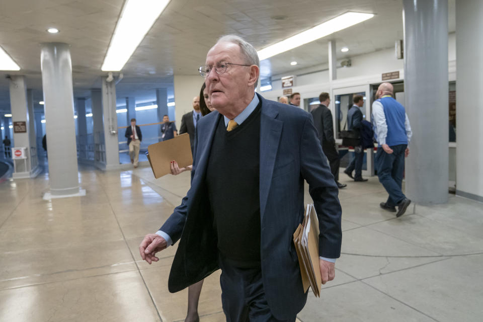 FILE - In this Feb. 12, 2019, file photo, Sen. Lamar Alexander, R-Tenn., walks to the Senate at the Capitol in Washington. A new study says about once in every six times someone is taken to an emergency room or checks in to a hospital as an in-patient, the treatment is followed by a “surprise” medical bill. (AP Photo/J. Scott Applewhite, File)