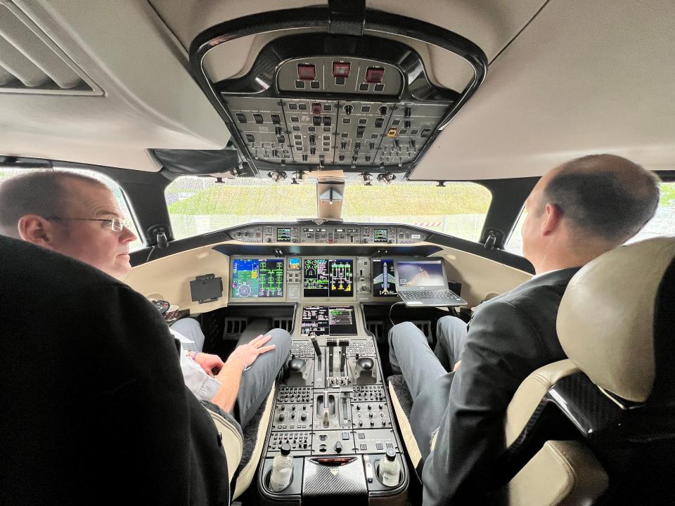 Two pilots sit in the cockpit of a VistaJet Bombardier Global 7500