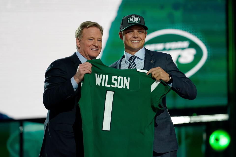 BYU quarterback Zach Wilson, right, poses for a photo with NFL Commissioner Roger Goodell after being drafted by the New York Jets in the first round of the NFL football draft, Thursday, April 29, 2021, in Cleveland.