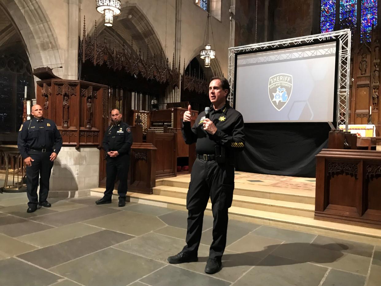 Oakland County Sheriff Michael Bouchard talks on Monday night, May 13, 2024, to a packed audience at Christ Church Cranbrook about the burglary threat to houses from "transnational gangs." Also there, from left, were Capt. Tom Van Simaeys of the Bloomfield Hills police and Bloomfield Township police Chief James Gallagher.