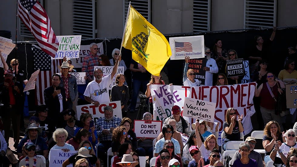 People carry signs and flags as several hundred anti-mandate demonstrators rally outside the Capitol during a special legislative session considering bills targeting COVID-19 vaccine mandates, on Nov. 16, 2021, in Tallahassee, Fla. 