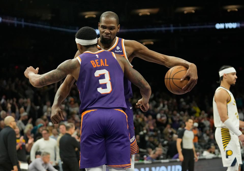 Phoenix Suns forward Kevin Durant (35) and guard Bradley Beal (3) celebrate after beating the Indiana Pacers 117-110 at Footprint Center in Phoenix on Jan. 21, 2024.