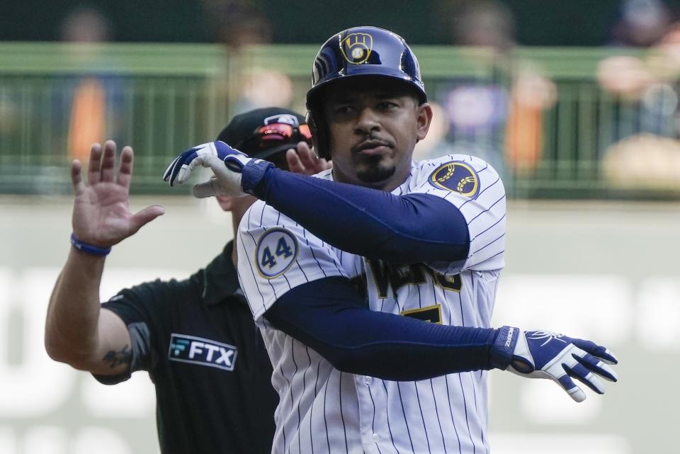 Milwaukee Brewers' Eduardo Escobar reacts after hitting an RBI double during the fifth inning of a baseball game against the Chicago Cubs Sunday, Sept. 19, 2021, in Milwaukee. (AP Photo/Morry Gash)