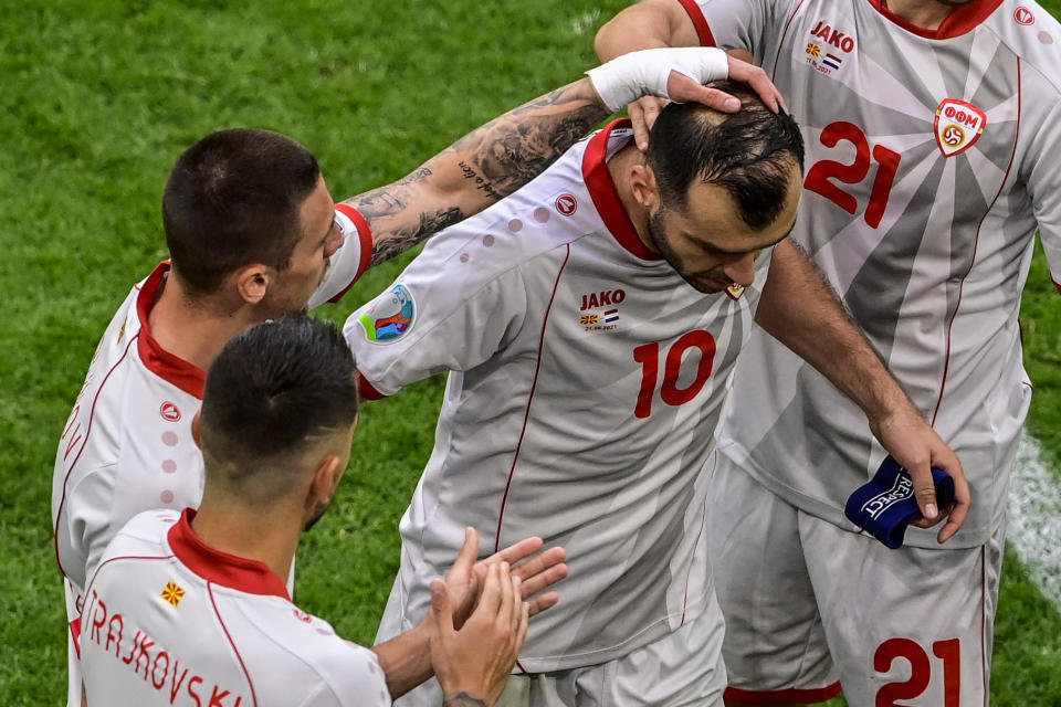 North Macedonia's Goran Pandev leaves the pitch while applauded and embraced by teammates during the Euro 2020 soccer championship group C match between The Netherlands and North Macedonia at the Johan Cruyff ArenA in Amsterdam, Netherlands, Monday, June 21, 2021. (Olaf Kraak, Pool via AP)