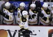 Boston Bruins defenseman Torey Krug celebrates his goal with teammates during the second period of Game 4 of a first-round NHL hockey playoff series against the Detroit Red Wings in Detroit, Thursday, April 24, 2014. (AP Photo/Carlos Osorio)