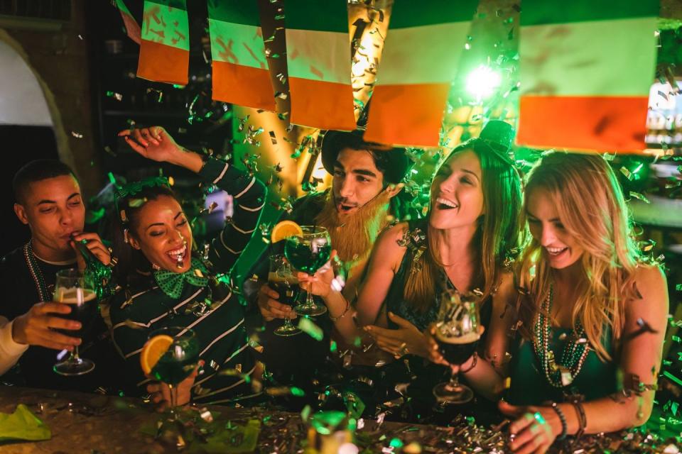 friends partying with drinks and confetti on saint patrick's day that could be captioned shenanigans squad on instagram