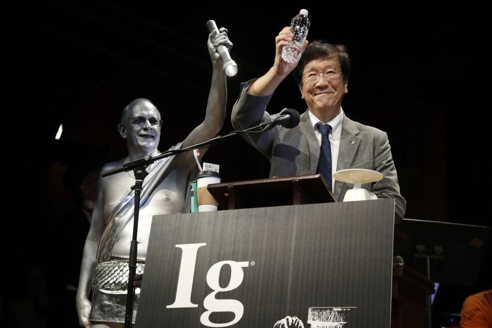 FILE - Shigeru Watanabe, of Japan, receives the Ig Nobel award in chemistry for estimating the total saliva volume produced per day by a typical five-year-old, Sept. 12, 2019, at Harvard University, in Cambridge, Mass. The 32nd annual Ig Nobel prize ceremony on Thursday, Sept. 15, 2022, was for the third year in a row a prerecorded affair because of the lingering effects of the coronavirus pandemic. (AP Photo/Elise Amendola, File)