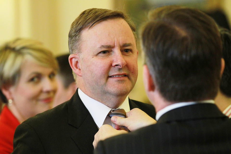 Chris Bowen MP fixes Deputy Prime Minister, Anthony Albanese's tie, as Tanya Plibersek MP looks on.