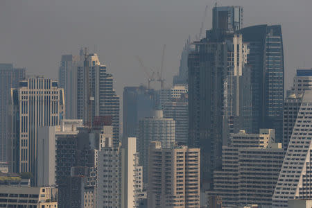 The skyline is seen through air pollution in Bangkok, Thailand February 15, 2018. REUTERS/Athit Perawongmetha