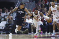 Cleveland Cavaliers guard Donovan Mitchell, center, pushes the ball upcourt against Orlando Magic forward Paolo Banchero (5) during the first half of Game 2 of an NBA basketball first-round playoff series, Monday, April 22, 2024, in Cleveland. (AP Photo/Ron Schwane)