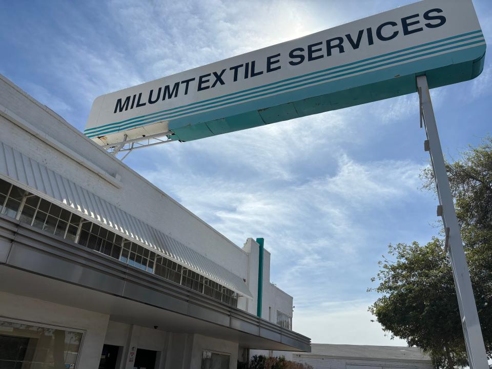 The Milum Textile Services sign marks the former industrial laundry's site. Its owners, Craig and Marilyn Milum said the sign is in need of repairs, along with the rest of the building.