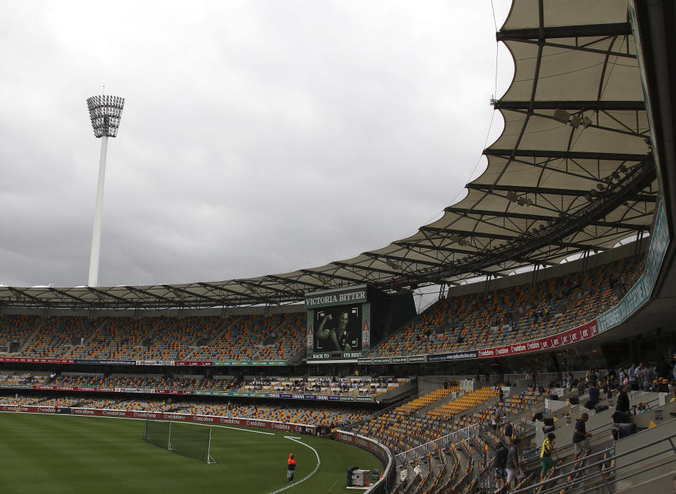 FILE - Spectators make their way home after play had been suspended due to heavy rain during the second day of the first cricket test match between Australia and South Africa at the Gabba stadium in Brisbane, Australia, on Nov. 10, 2012. Brisbane Olympics organizers have been advised to consider building a new stadium on a greenfield site near the city's downtown and scrap plans to demolish and rebuild a century-old cricket stadium as the centerpiece for the 2032 Games.(AP Photo/Tertius Pickard, File)