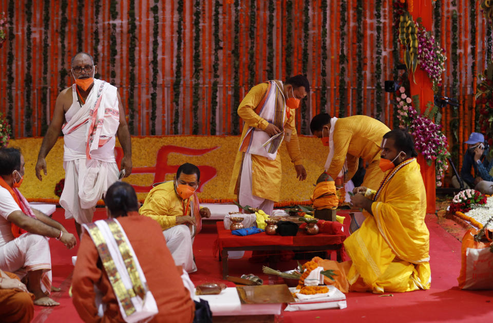 Hindu priests prepare the site for a groundbreaking ceremony of a temple dedicated to the Hindu god Ram in Ayodhya, India, Wednesday, Aug. 5, 2020. The coronavirus is restricting a large crowd, but Hindus were joyful before Prime Minister Narendra Modi breaks ground Wednesday on a long-awaited temple of their most revered god Ram at the site of a demolished 16th century mosque in northern India. (AP Photo/Rajesh Kumar Singh)