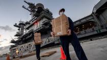 FILE PHOTO: U.S. Navy sailors assigned to the aircraft carrier USS Theodore Roosevelt carry meals in Guam