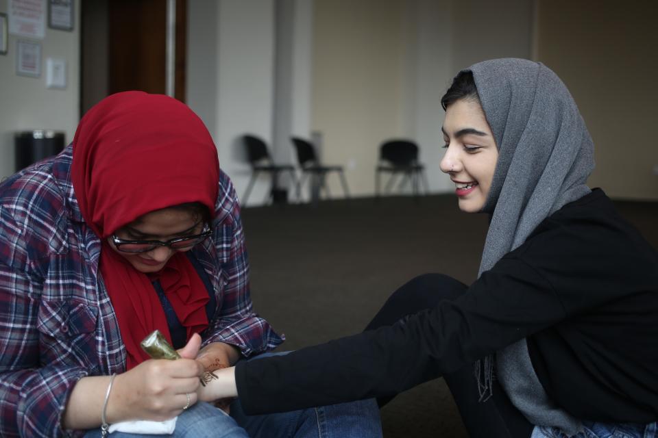 Fatima Elif (R) gets a Henna before Eid-ul-Fitr, a holiday celebrated by Muslims worldwide that marks the end of the Islamic holy month of fasting 'Ramadan' at Islamic Center of New York University in Manhattan borough of New York, United States on June 23, 2017.