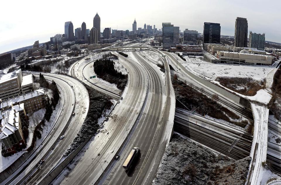 In this aerial photo taken with a fisheye lens looking south toward downtown Atlanta, the ice-covered interstate system shows the remnants of a winter snow storm Wednesday, Jan. 29, 2014, in Atlanta. While such amounts of accumulation barely quality as a storm in the north, it was enough to paralyze the Deep South. (AP Photo/David Tulis)