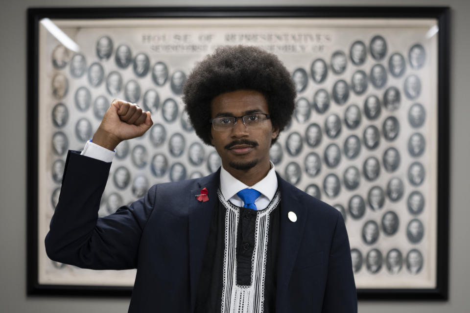 State Rep. Justin Pearson, D-Memphis, poses for a portrait in front of a 1930s Tennessee House of Representatives composite in a hallway outside his office at the Cordell Hull Building, Monday, April 17, 2023, in Nashville, Tenn. (AP Photo/George Walker IV)