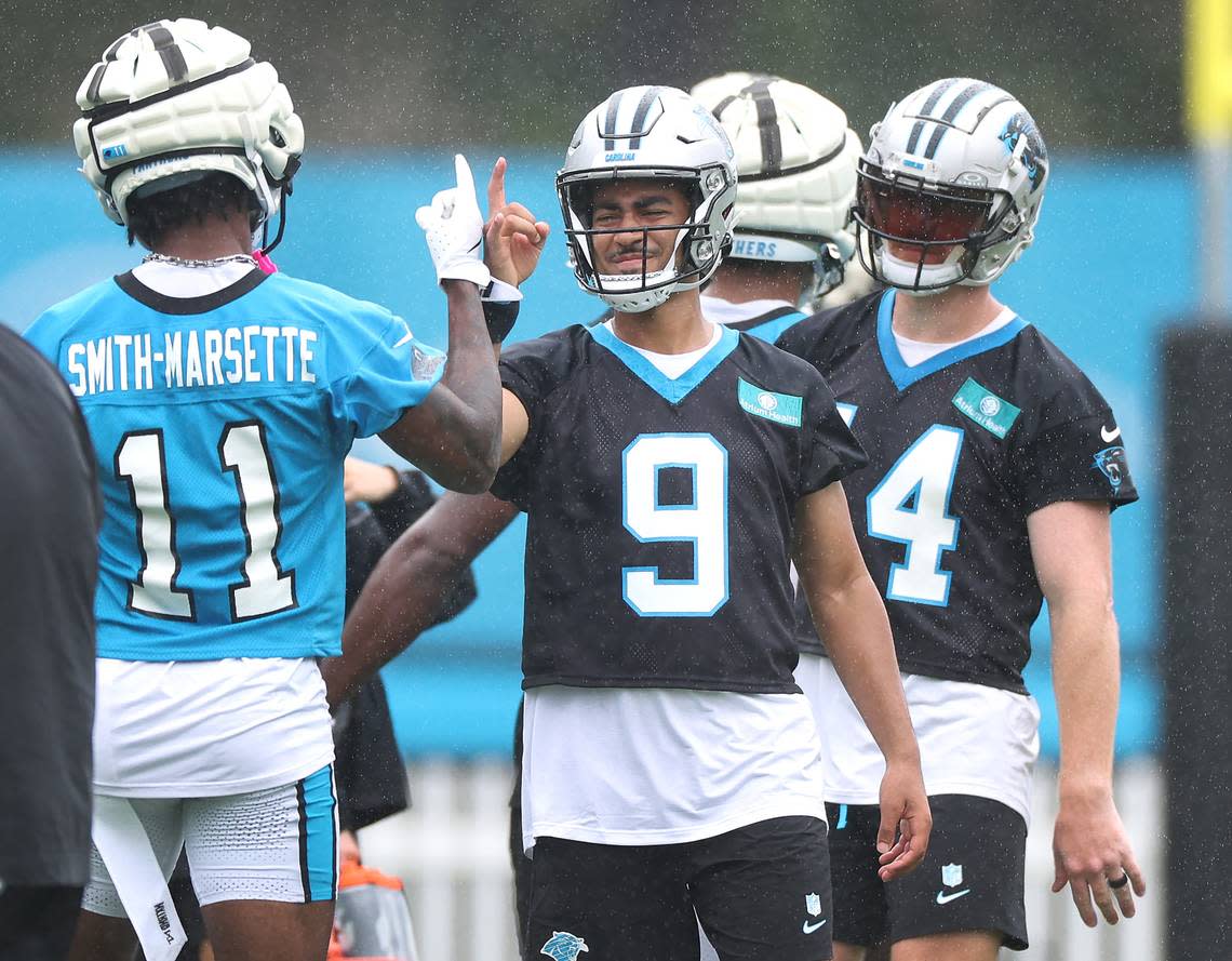 Carolina Panthers wide receiver Ihmir Smith-Marsette, left and quarterback Bryce Young, right, finish up a handshake prior to a new set of drills on Thursday, July 25, 2024.