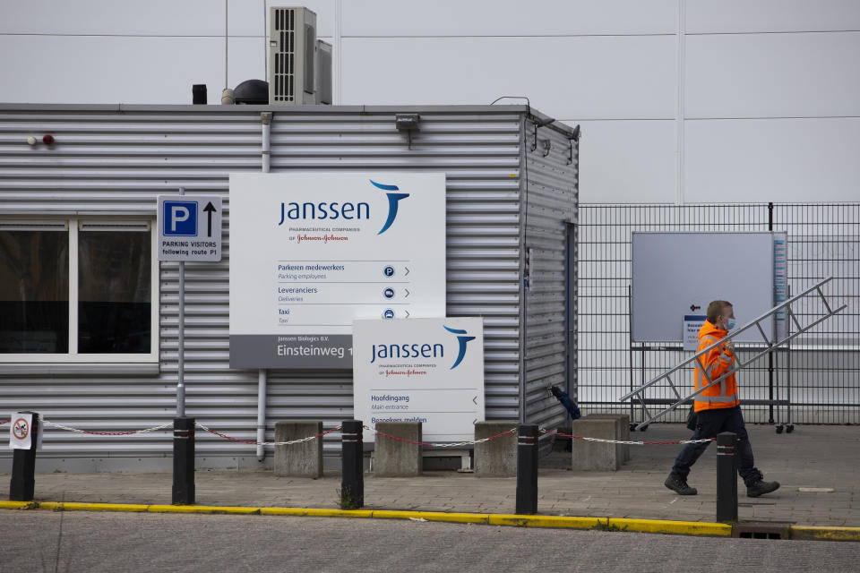 A man passes the entrance of the Janssen Pharmaceuticals company, which is owned by Johnson & Johnson, in Leiden, Netherlands, Wednesday, April 14, 2021. European nations from across the continent are scrambling to react to Johnson & Johnson's delay of the rollout for its COVID-19 vaccine amid reports of rare blood clots. (AP Photo/Peter Dejong)