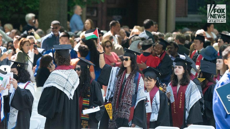 Yale graduates protest the Hamas-Israel war, one of them is waving a Palestine flag