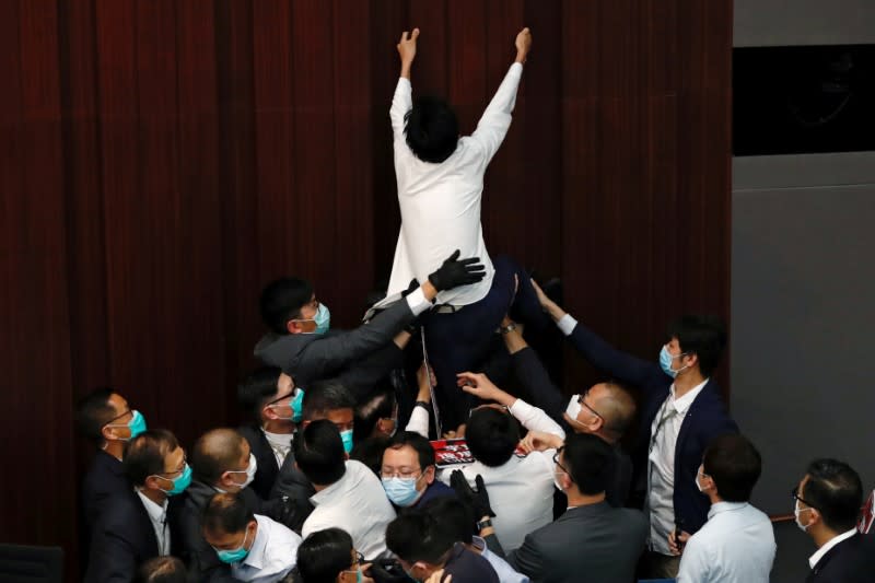 FILE PHOTO: Pan-democratic legislator Eddie Chu Hoi-dick scuffles with security and pro-China legislators during Legislative Council’s House Committee meeting, in Hong Kong