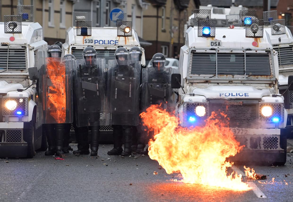 <p>Nationalists attack police on Springfield Road just up from peace wall interface gates, which divide the nationalist and loyalist communities</p> (Getty)