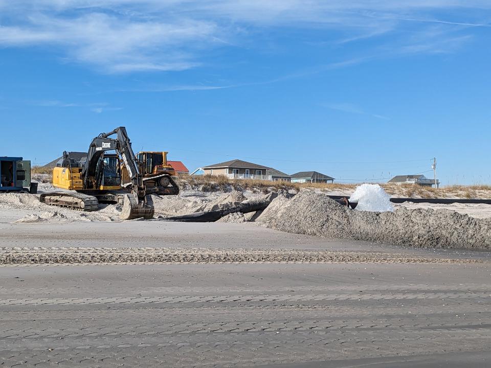 Material dredged from waterways on the Intracoastal Waterway side of Topsail Beach is sprayed onto the town's beach after being piped over.
