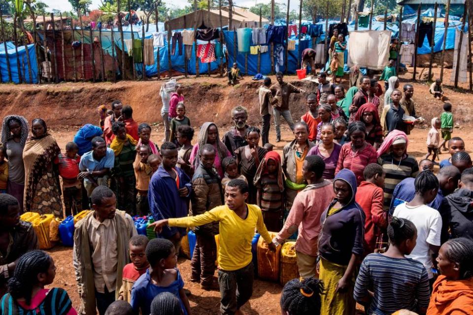 Displaced Gedeo people queue for water in West Guji, Ethiopia